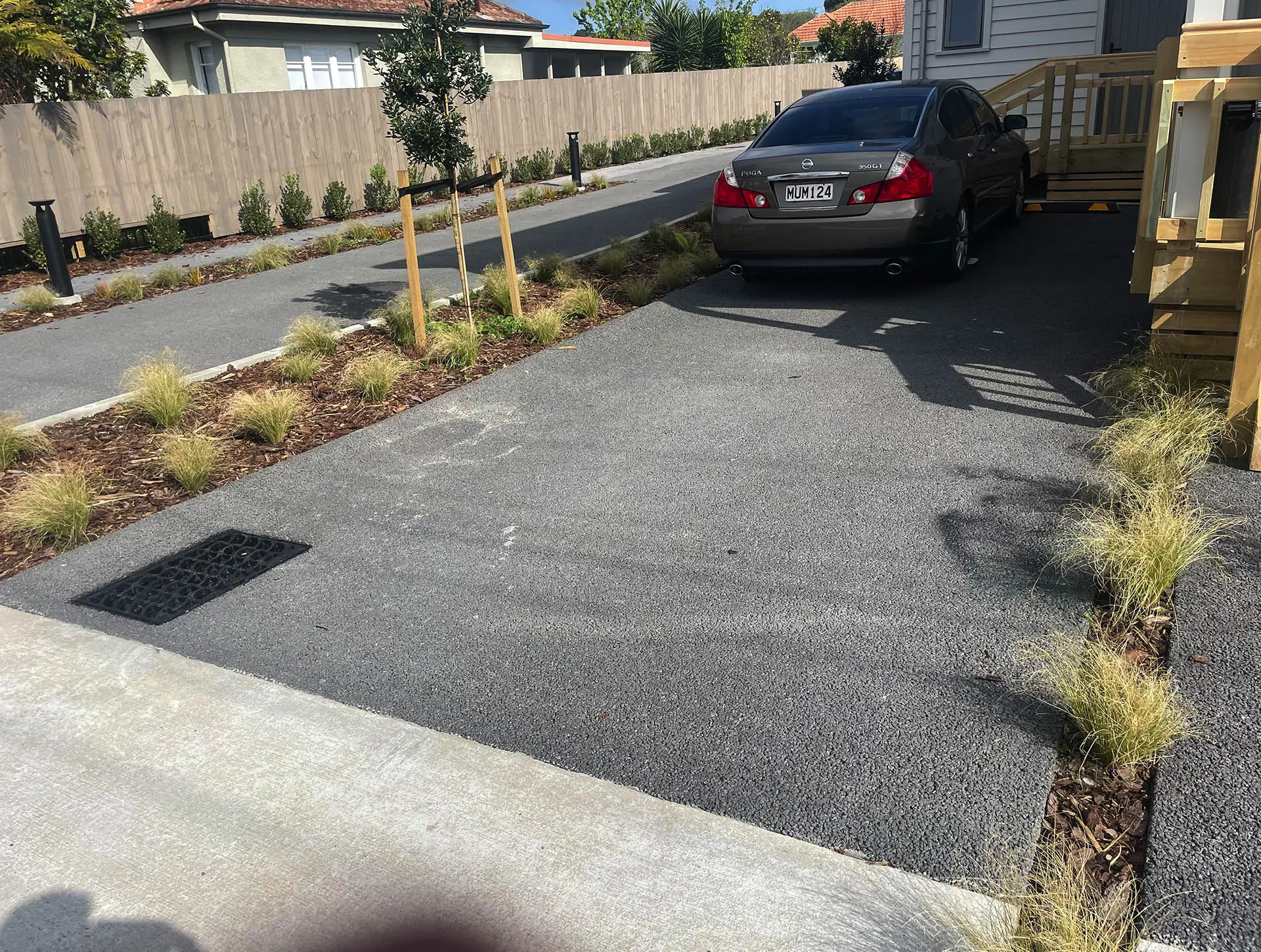 Permeable concrete driveway in front of modern residential buildings.