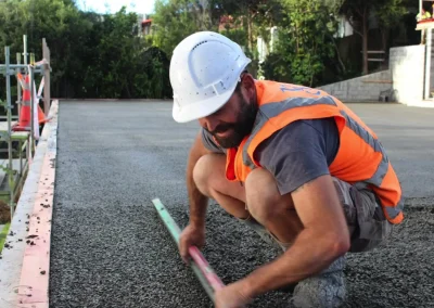 Permeable Concrete New Zealand professional installation team raking concrete