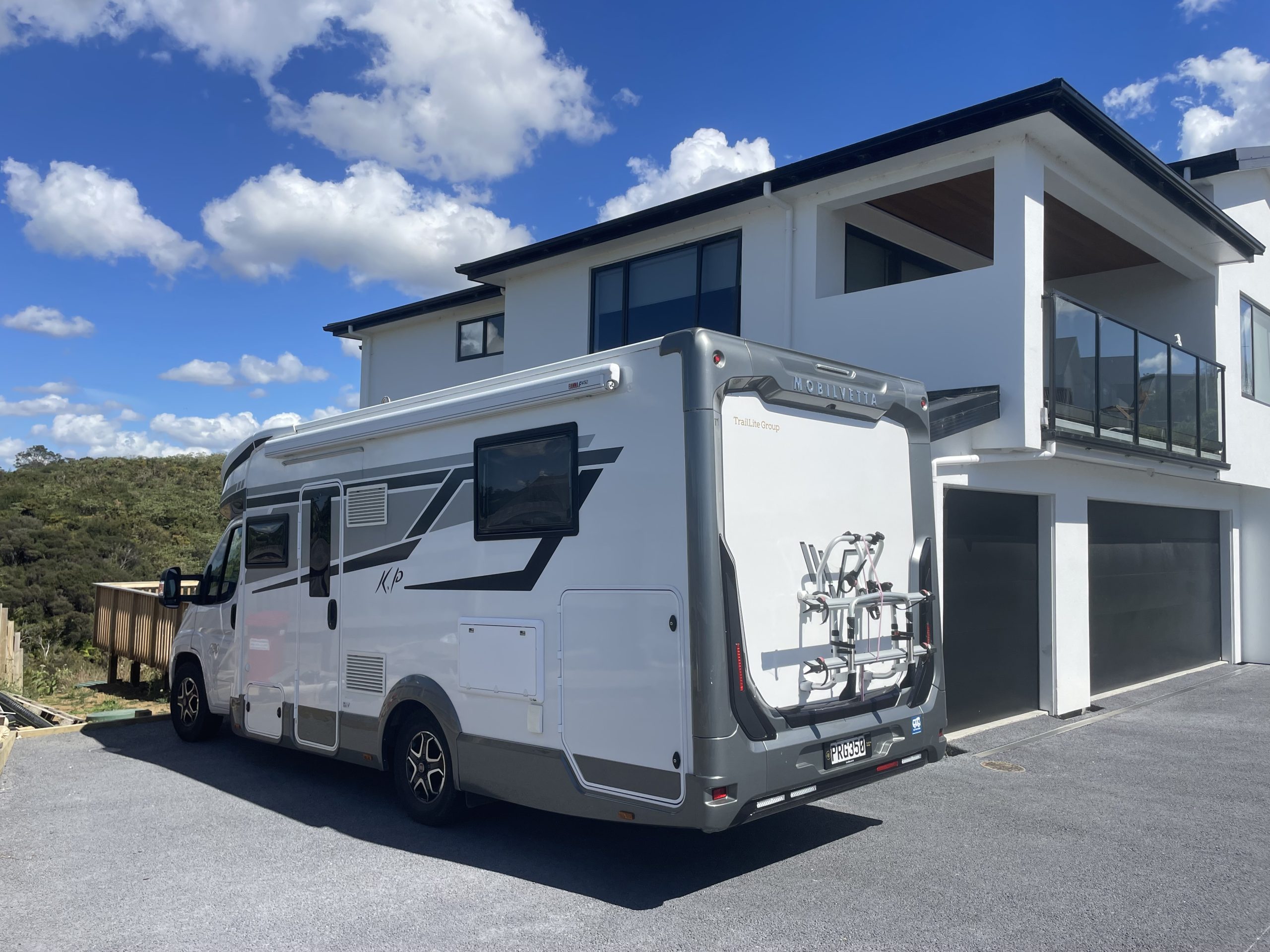 Permeable concrete driveway in front of modern residential buildings.